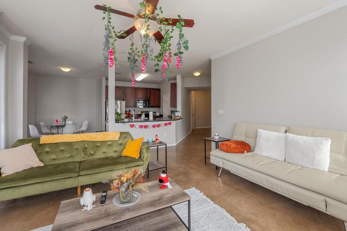 910 West 25th Street, Unit 406 Austin, TX 78705 - Photo 2 of 18 a living room with furniture and a flat screen tv