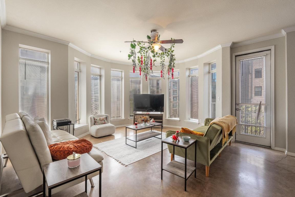 910 West 25th Street, Unit 406 Austin, TX 78705 - Photo 3 of 18 a living room with furniture and a chandelier