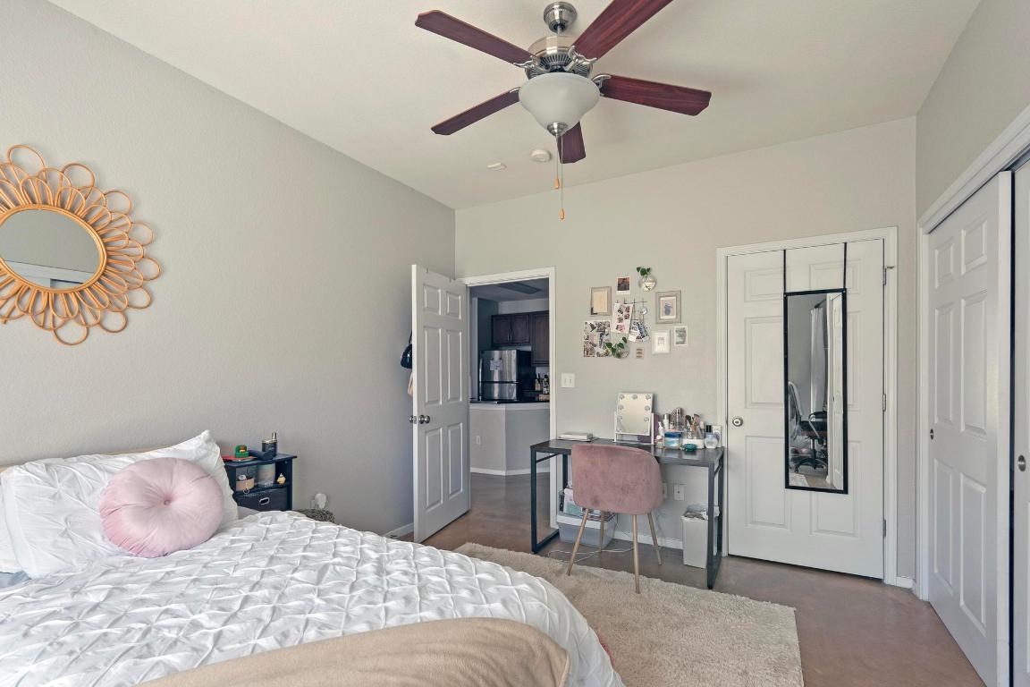 910 West 25th Street, Unit 406 Austin, TX 78705 - Photo 9 of 18 a bedroom with a bed and a chandelier