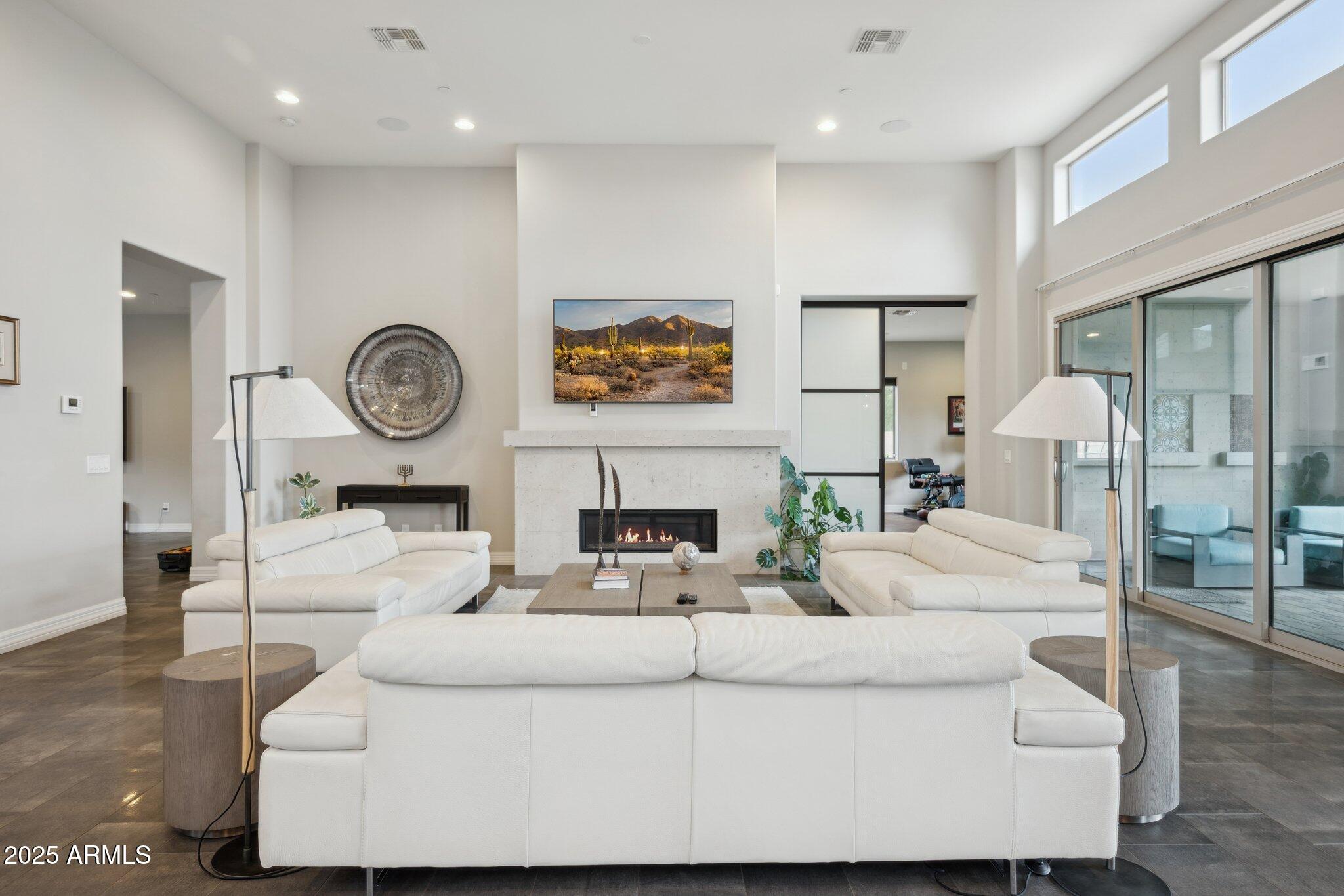 5237 East Montgomery Road Cave Creek, AZ 85331 - Photo 10 of 79 a living room with furniture a clock and a fireplace