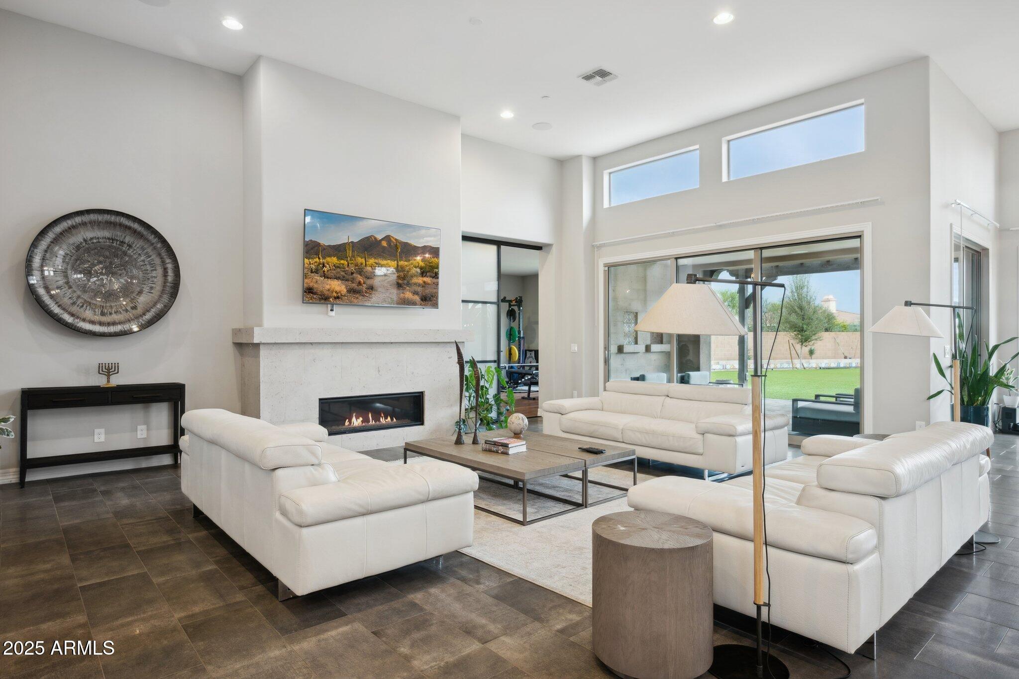 5237 East Montgomery Road Cave Creek, AZ 85331 - Photo 12 of 79 a living room with furniture a fireplace and a large window