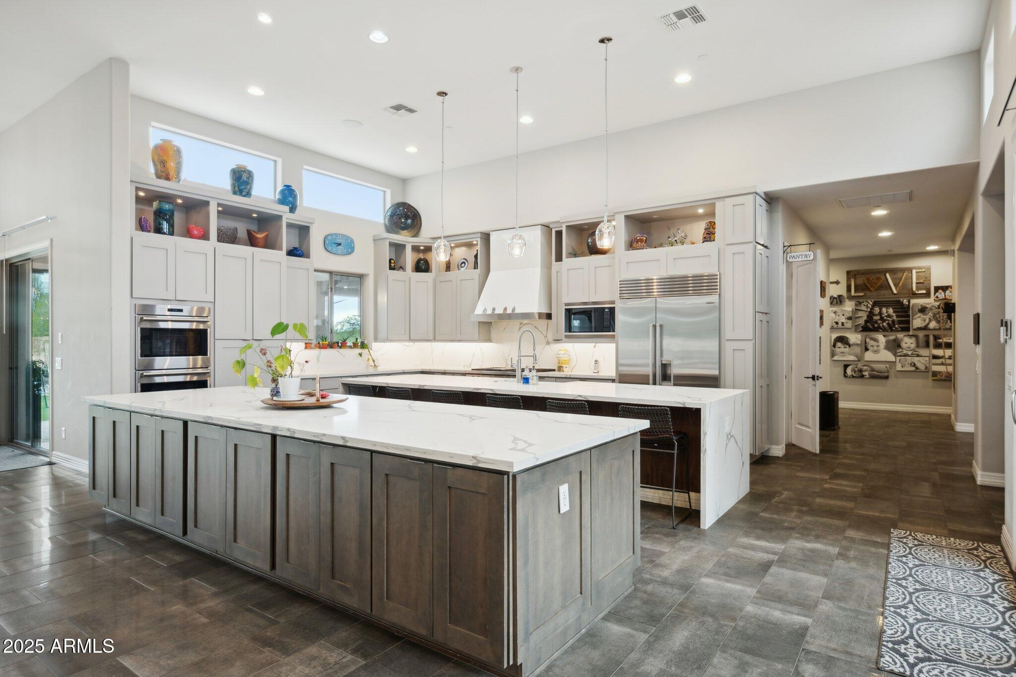5237 East Montgomery Road Cave Creek, AZ 85331 - Photo 18 of 79 a kitchen with stainless steel appliances kitchen island granite countertop a sink and cabinets