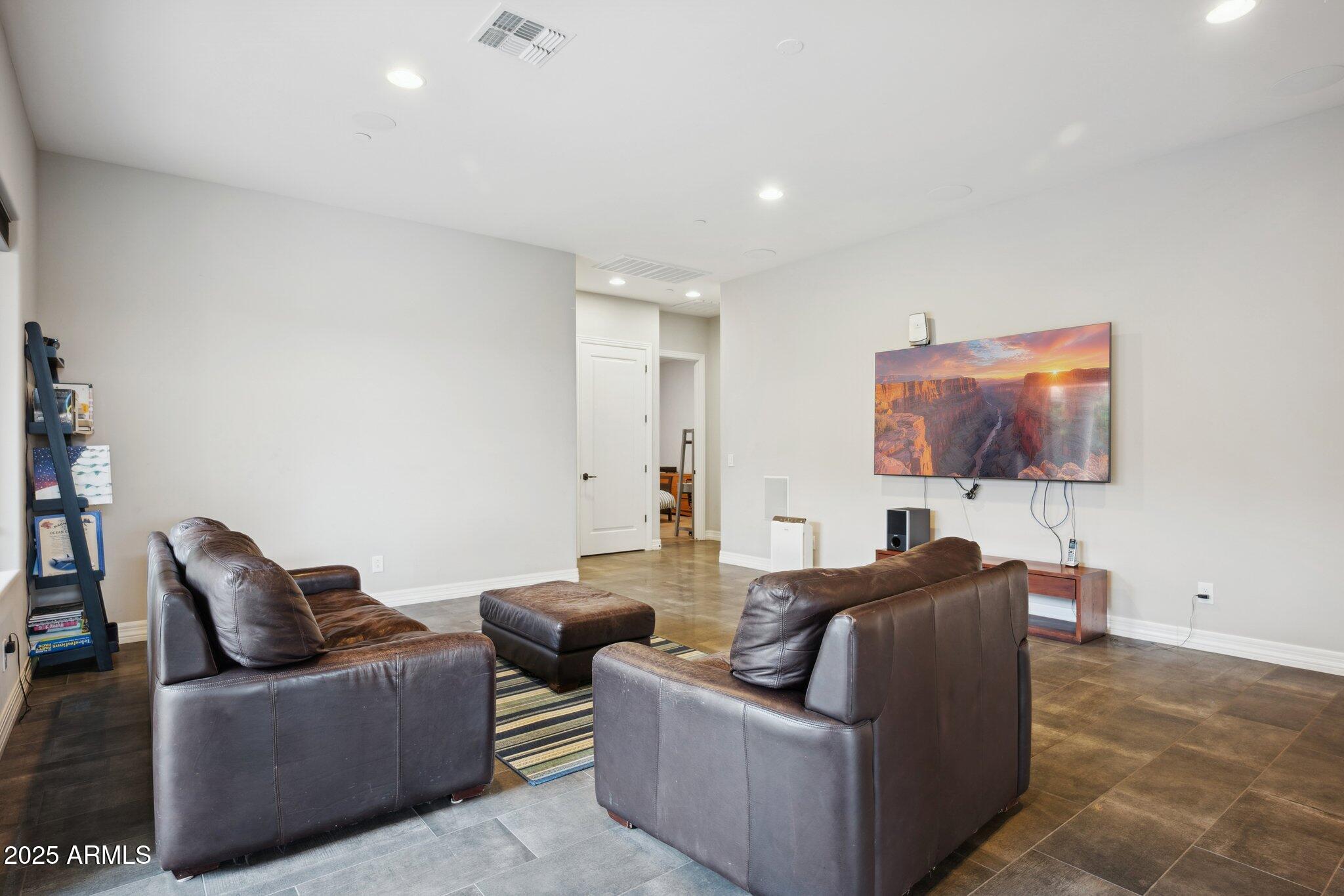 5237 East Montgomery Road Cave Creek, AZ 85331 - Photo 26 of 79 a living room with furniture and a flat screen tv