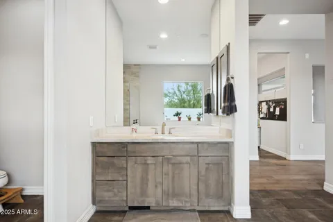 a bathroom with a granite countertop sink and a mirror