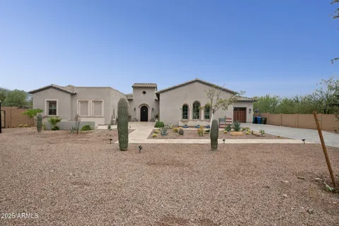 a living room with furniture a clock and a fireplace