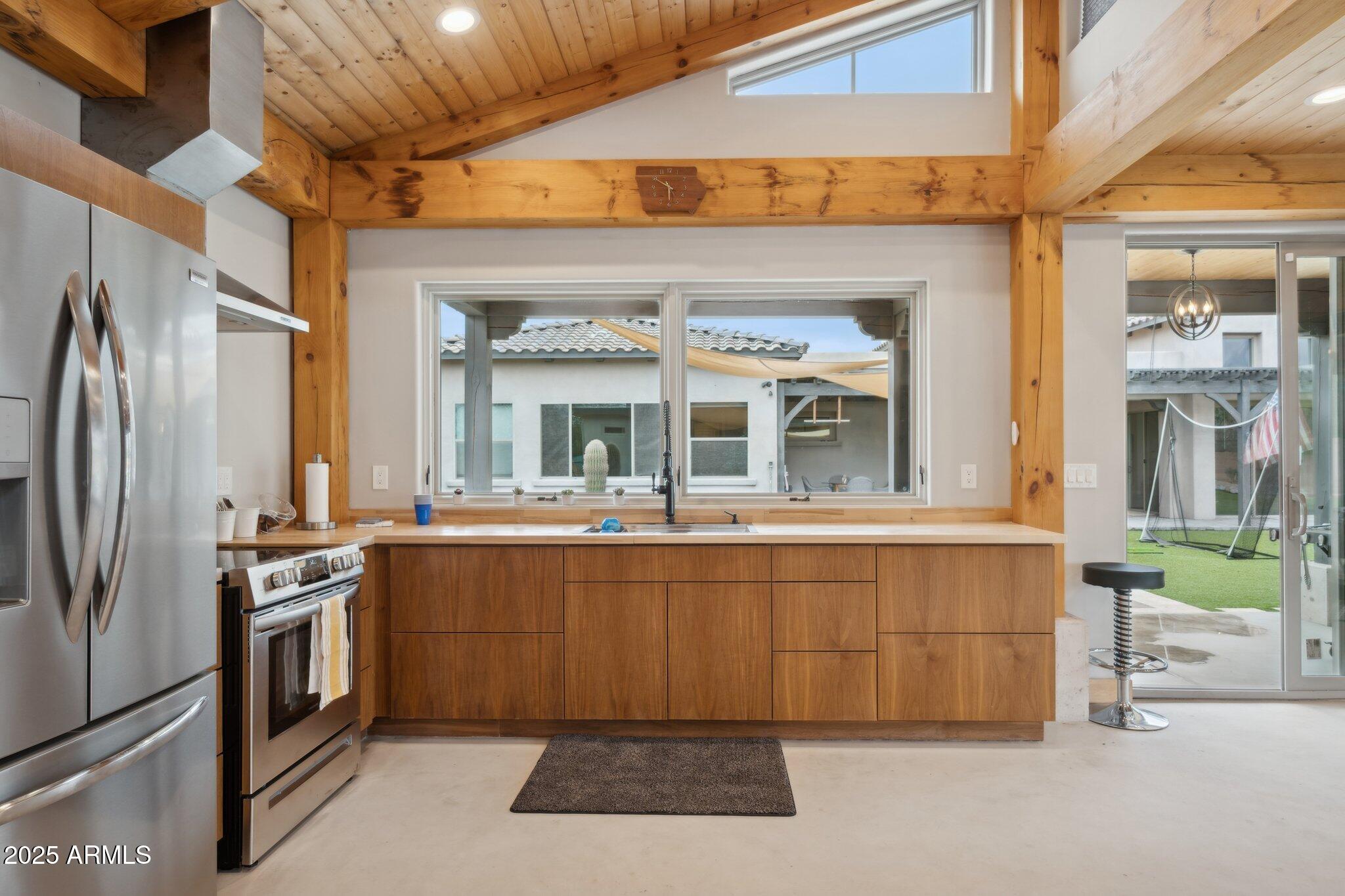 5237 East Montgomery Road Cave Creek, AZ 85331 - Photo 65 of 79 a kitchen with stainless steel appliances granite countertop a stove and a refrigerator