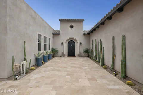 a living room with furniture a fireplace and a large window