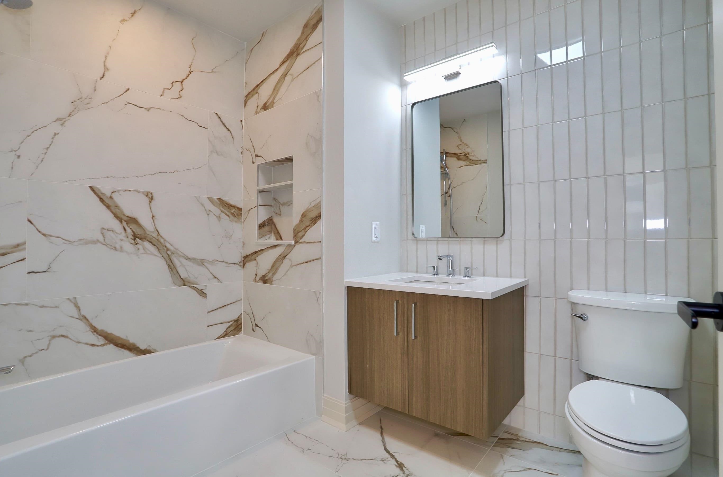 921 Madison Street, Unit 401 Hoboken, NJ 07030 - Photo 16 of 32 a bathroom with a sink a toilet and shower