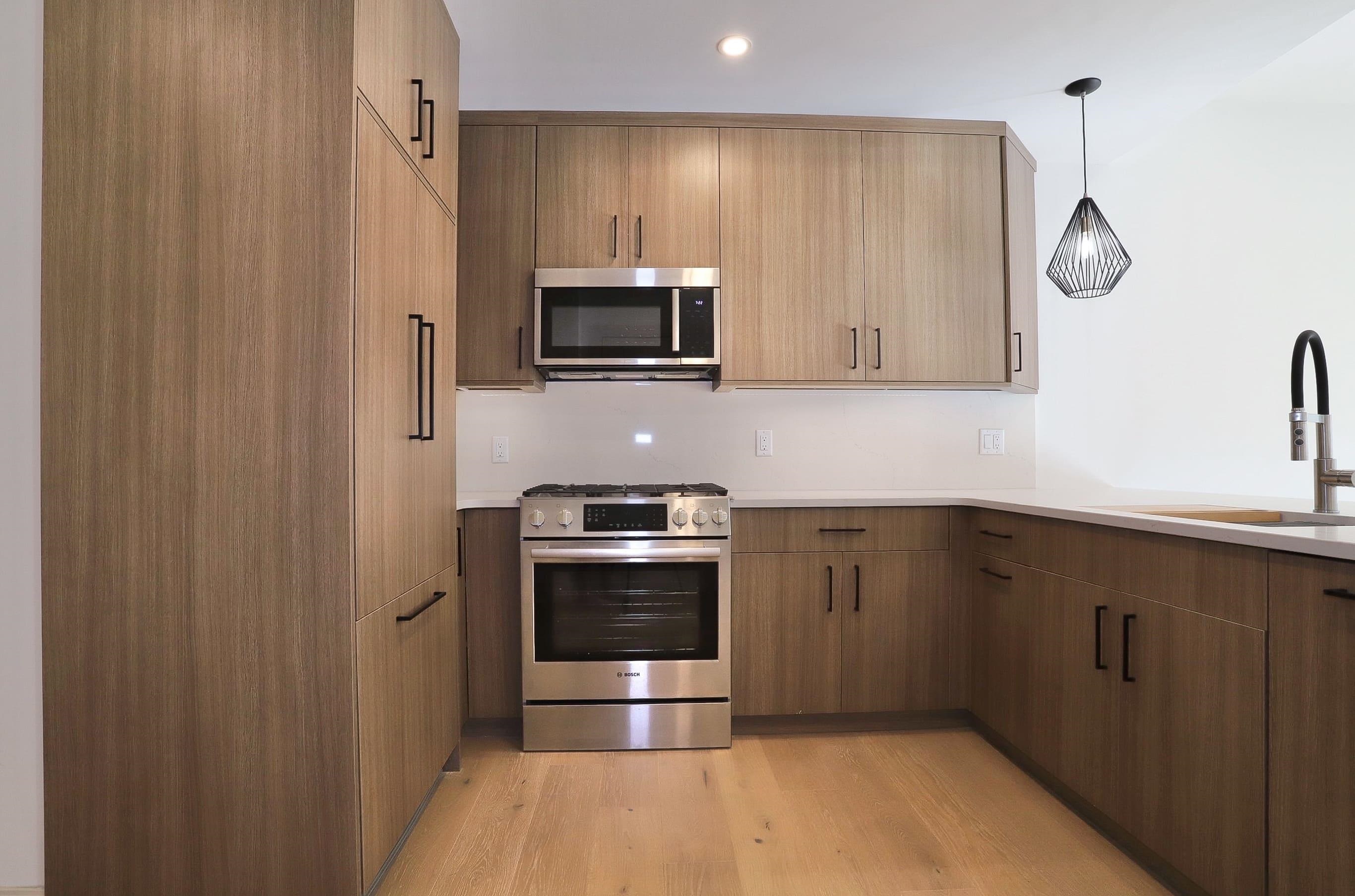 921 Madison Street, Unit 401 Hoboken, NJ 07030 - Photo 2 of 32 a kitchen with stainless steel appliances a stove microwave and sink