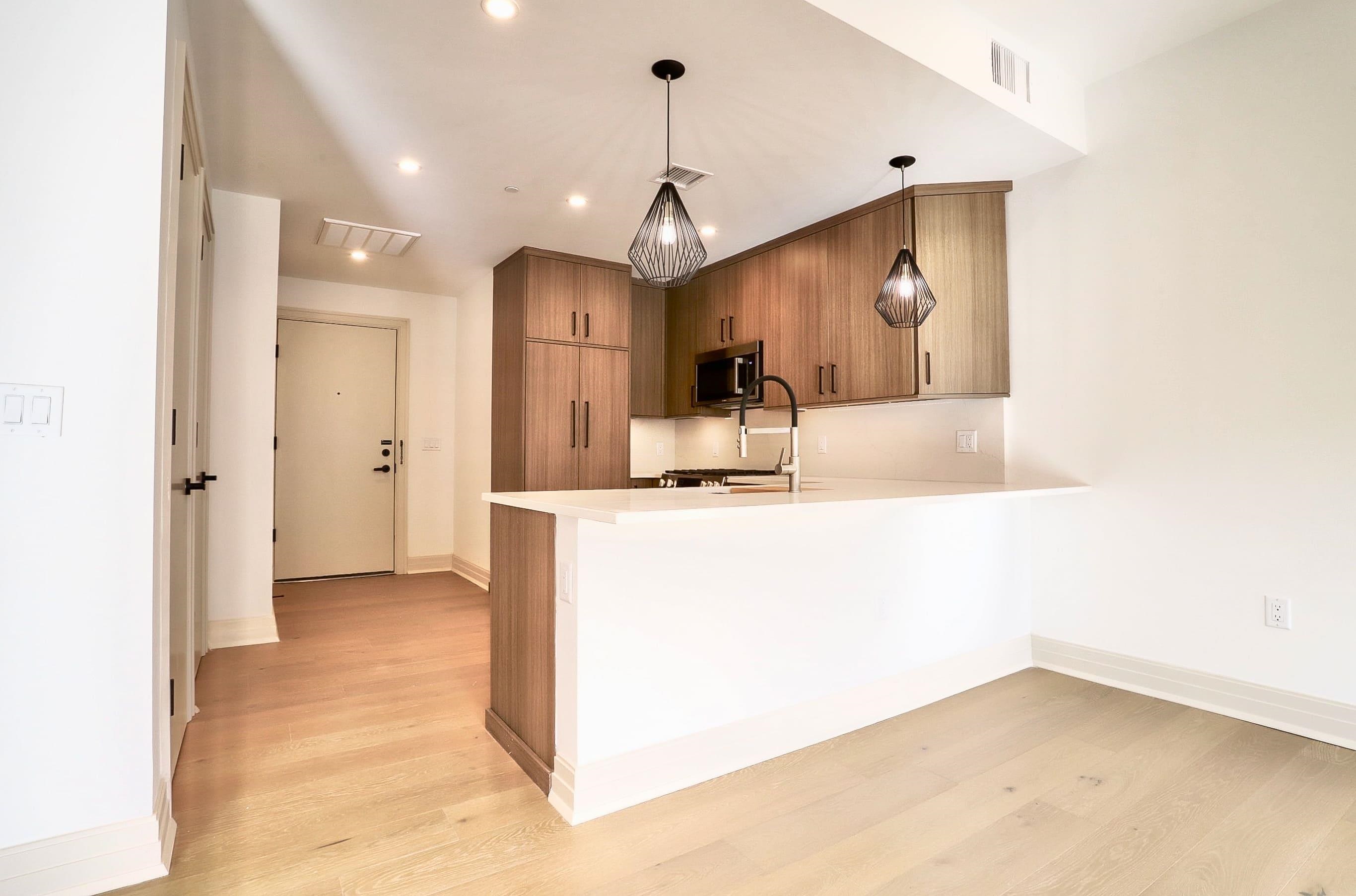 921 Madison Street, Unit 401 Hoboken, NJ 07030 - Photo 6 of 32 a view of a kitchen with a sink and a refrigerator