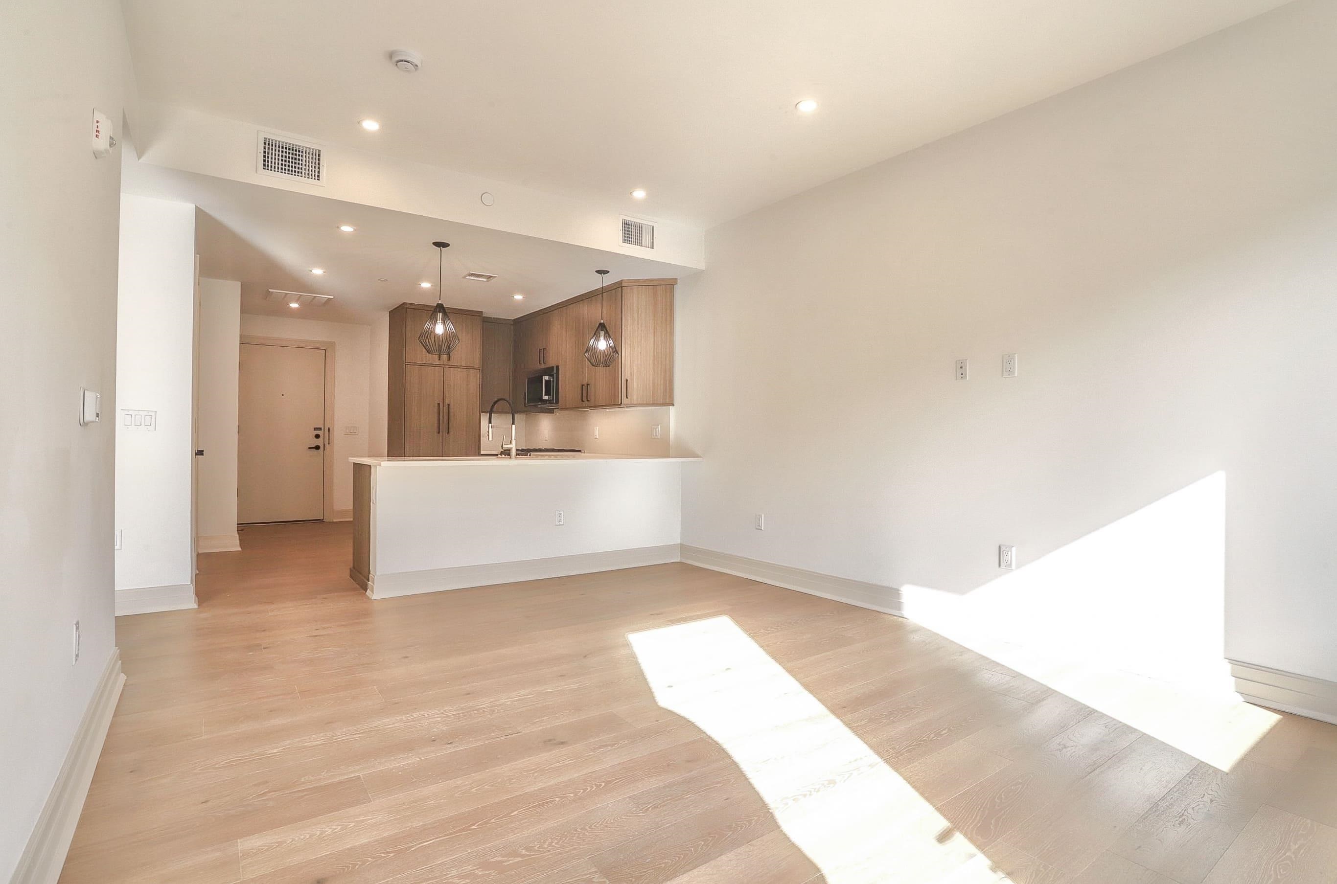 921 Madison Street, Unit 401 Hoboken, NJ 07030 - Photo 7 of 32 a view of a big room with wooden floor and windows