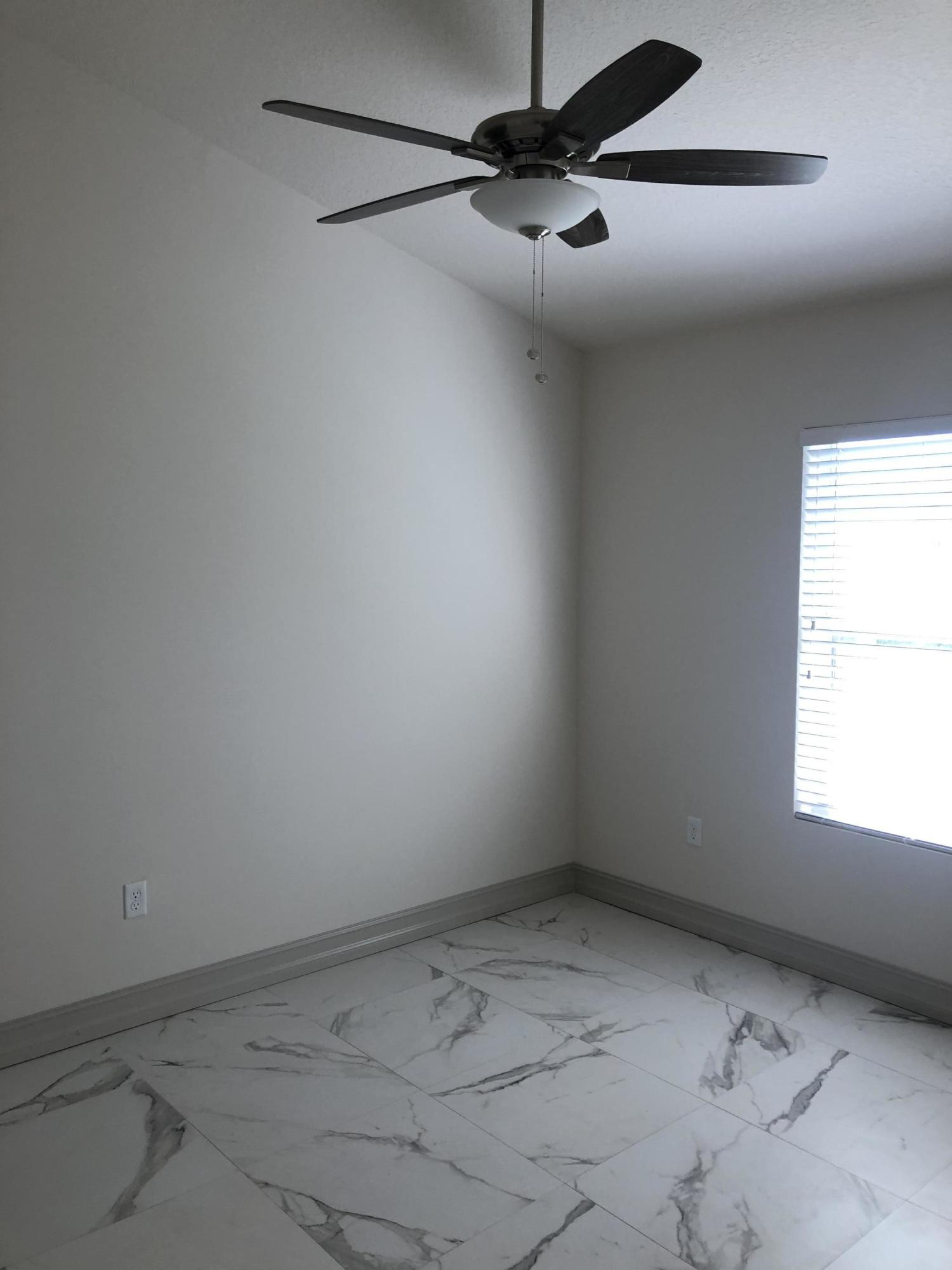 4936 Jefferson Road Delray Beach, FL 33445 - Photo 15 of 16 an empty room with a window