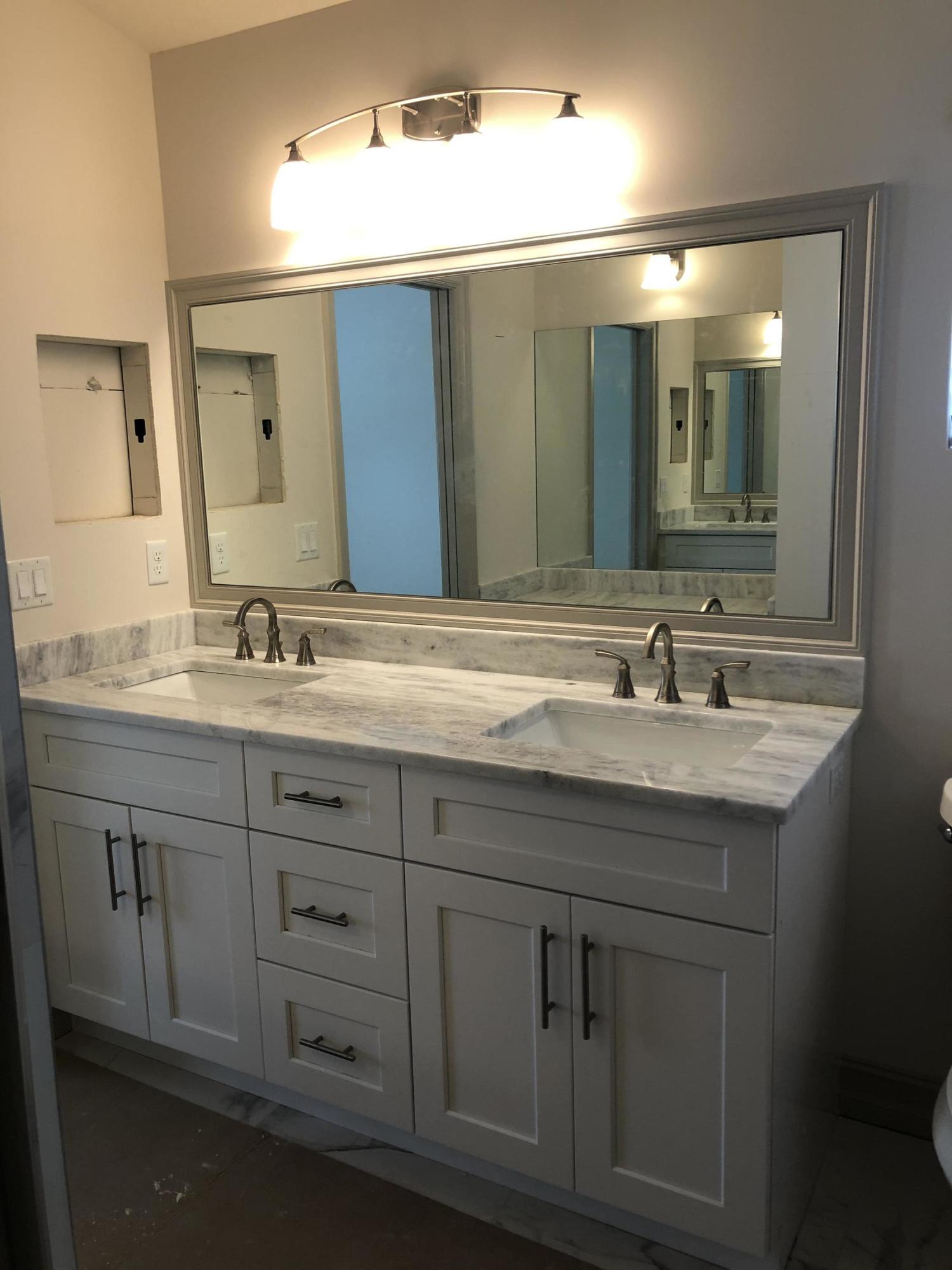 4936 Jefferson Road Delray Beach, FL 33445 - Photo 3 of 16 a bathroom with a sink vanity and mirror