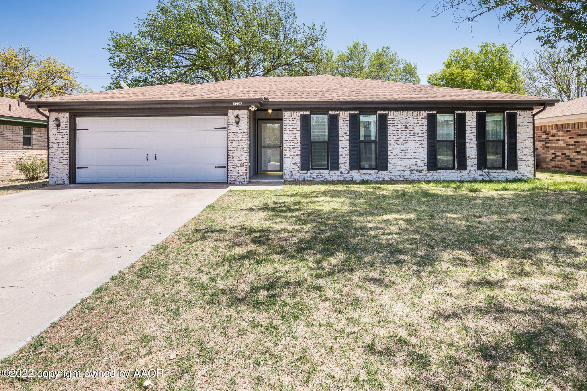 8205 Lamount Drive Amarillo, TX 79110 - Photo 1 of 21 front view of a house with a large window and a yard