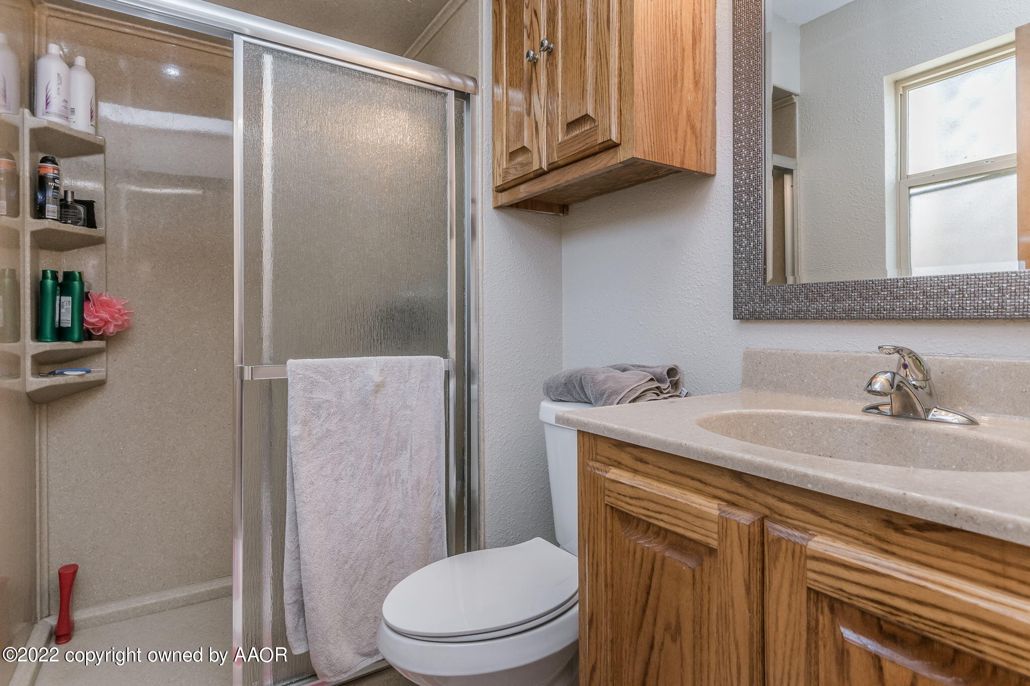 8205 Lamount Drive Amarillo, TX 79110 - Photo 13 of 21 a bathroom with a sink a toilet and shower