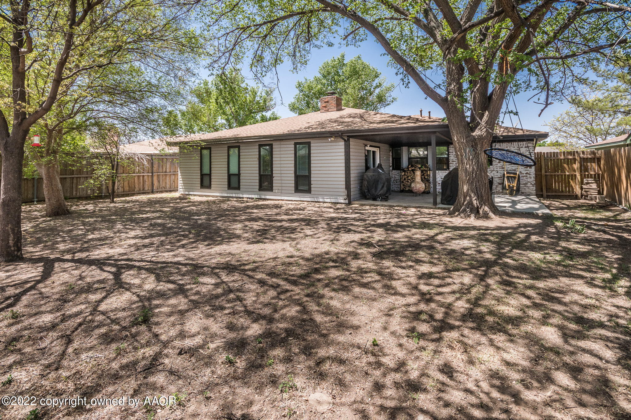 8205 Lamount Drive Amarillo, TX 79110 - Photo 20 of 21 a front view of a house with a garden