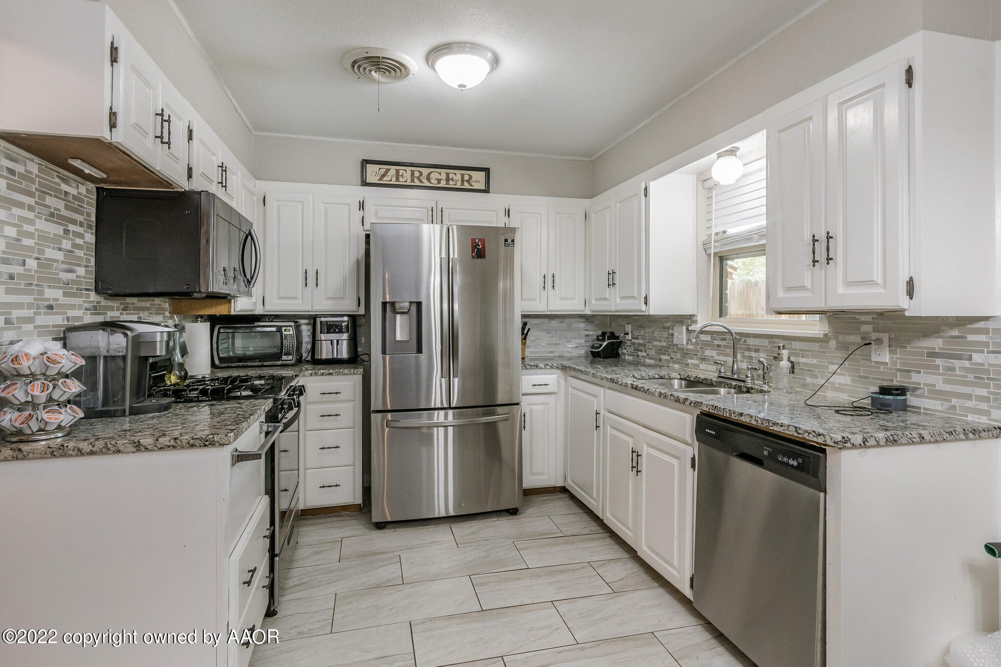 8205 Lamount Drive Amarillo, TX 79110 - Photo 8 of 21 a kitchen with stainless steel appliances granite countertop a refrigerator stove a sink and a microwave