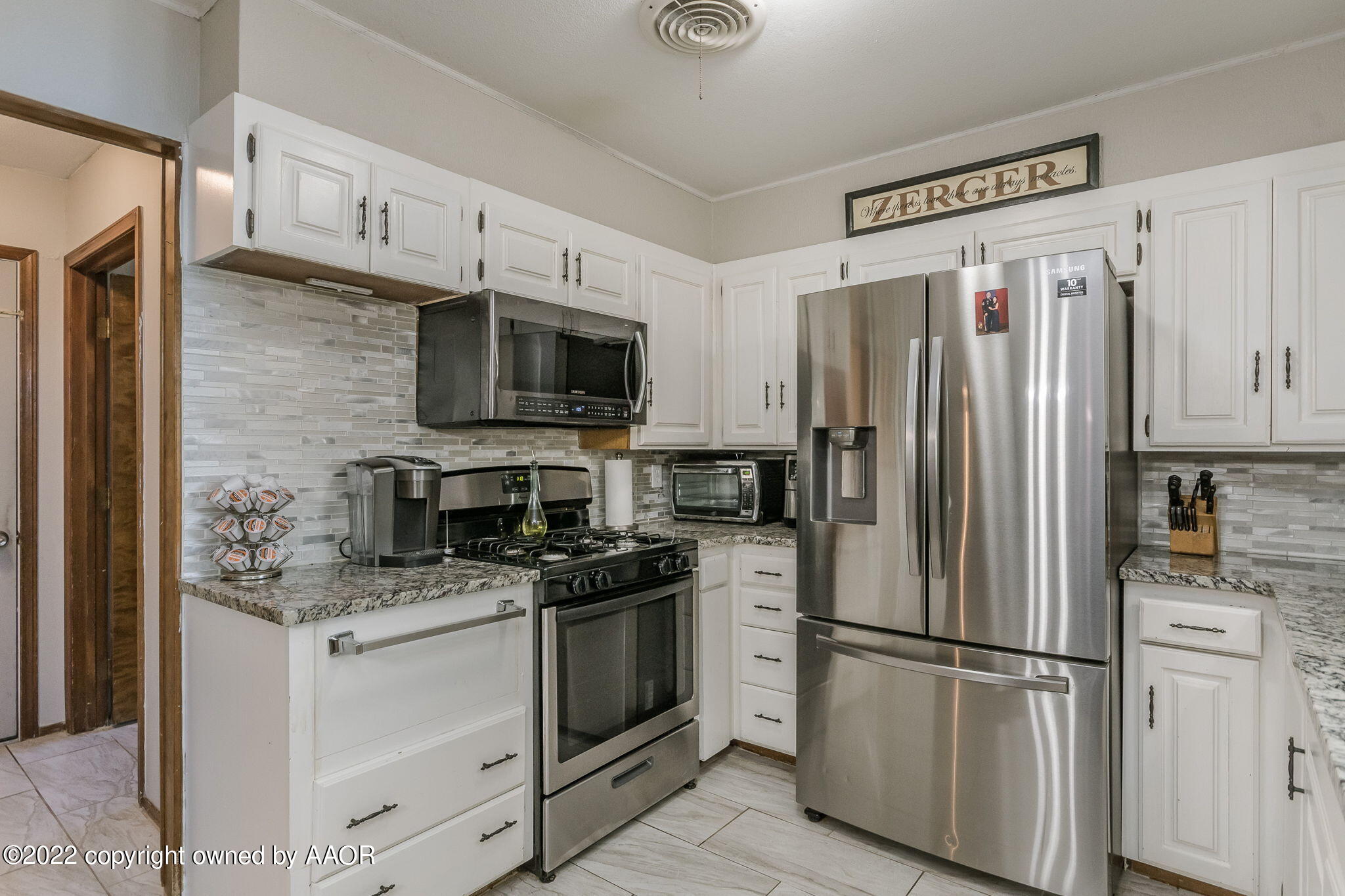 8205 Lamount Drive Amarillo, TX 79110 - Photo 9 of 21 a kitchen with stainless steel appliances a refrigerator stove and microwave