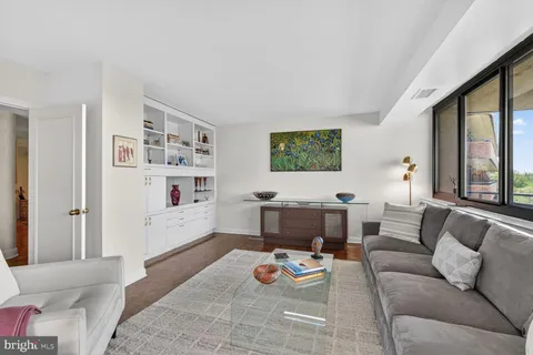 a living room with furniture and a book shelf