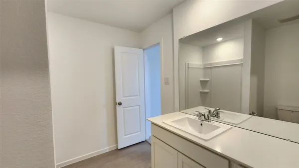 a bathroom with a sink a mirror and a vanity