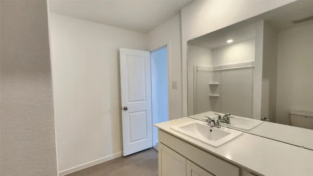 a bathroom with a sink a mirror and a vanity