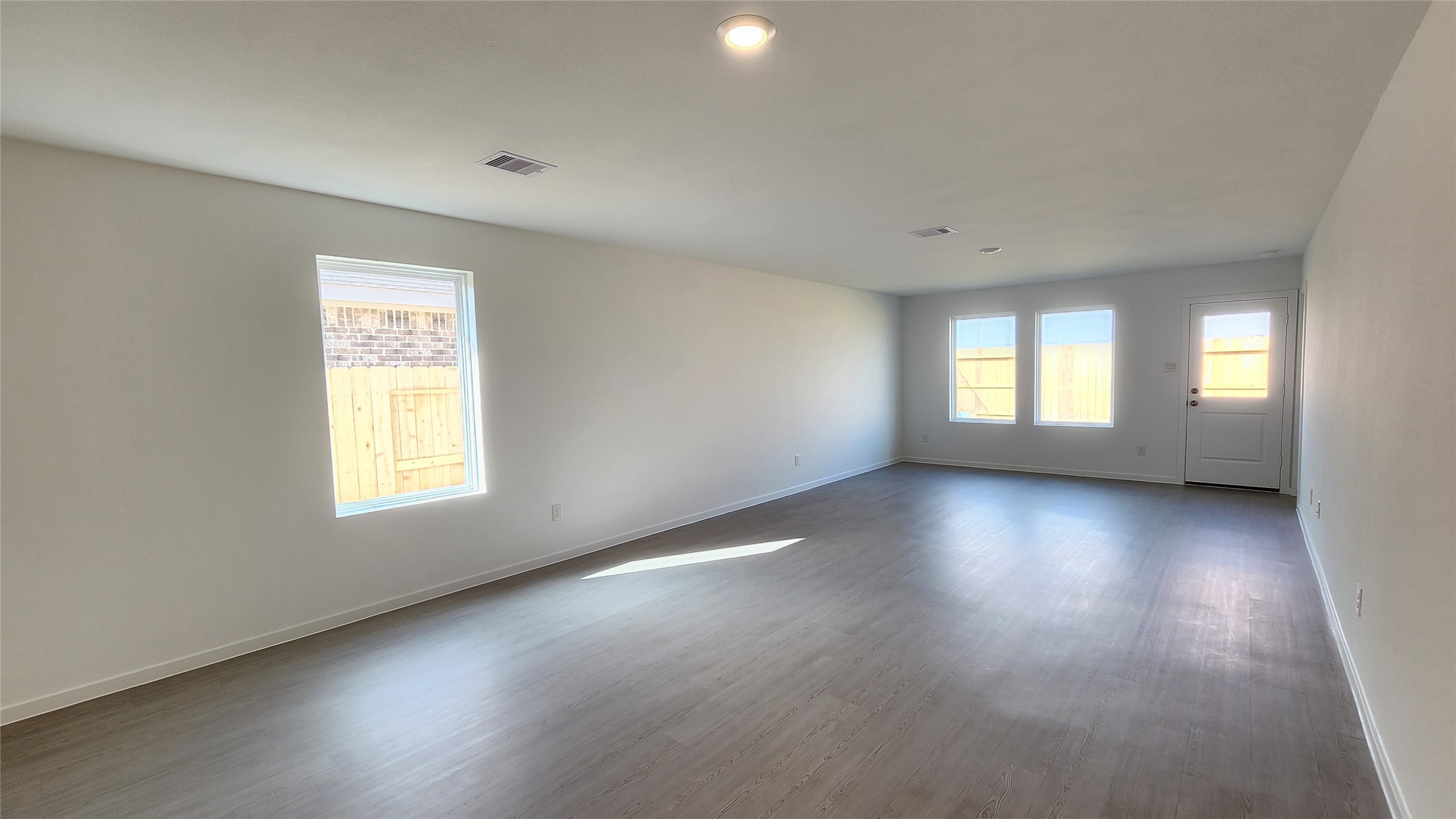 26850 Cascade Sunrise Street Katy, TX 77493 - Photo 9 of 40 an empty room with wooden floor and windows