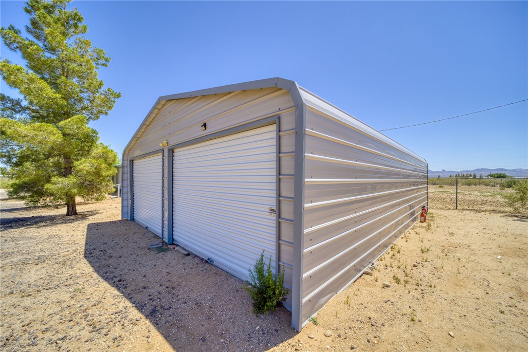 4745 Mormon Flat Road Golden Valley, AZ 86413 - Photo 3 of 49 a front view of a house with a yard