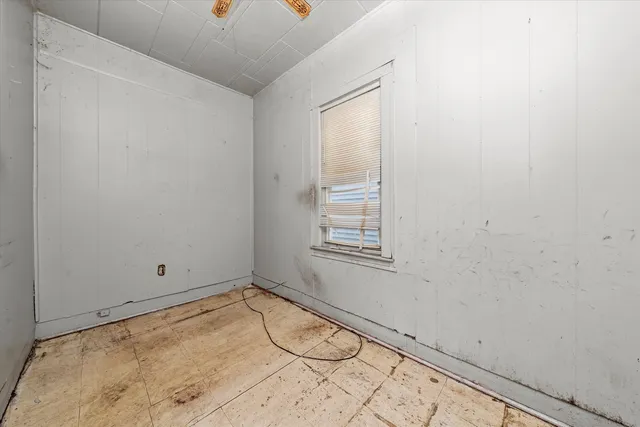 a view of a room with rack on the wall and a window