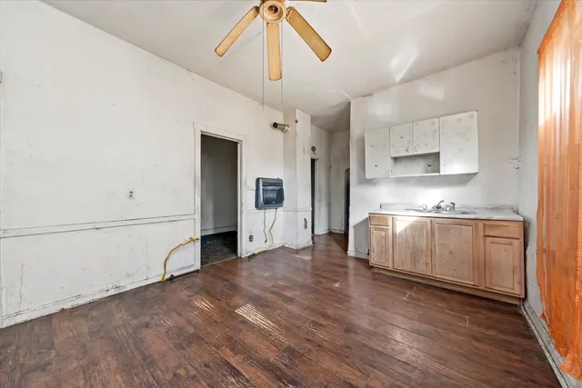 a view of a kitchen with a sink and cabinet