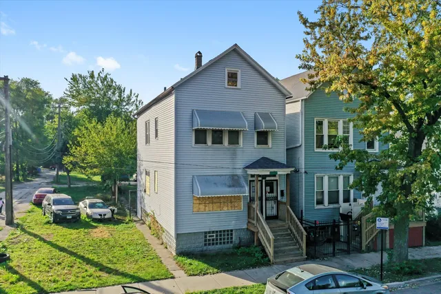 an aerial view of a houses with yard