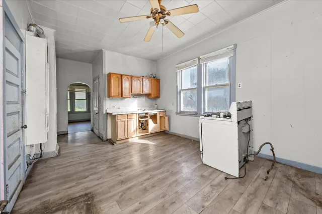 a view of kitchen with sink microwave and refrigerator