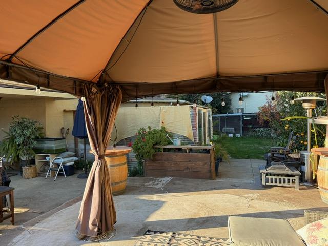7610 Miller Avenue Gilroy, CA 95020 - Photo 28 of 49 a view of a patio with a table and chairs under an umbrella