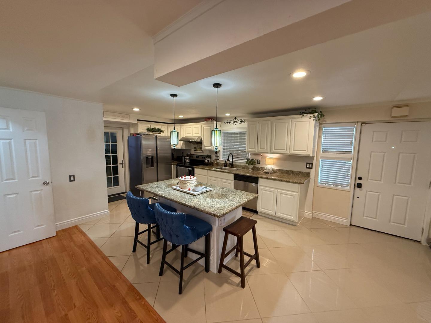 7610 Miller Avenue Gilroy, CA 95020 - Photo 4 of 49 a kitchen with stainless steel appliances kitchen island granite countertop a sink and cabinets