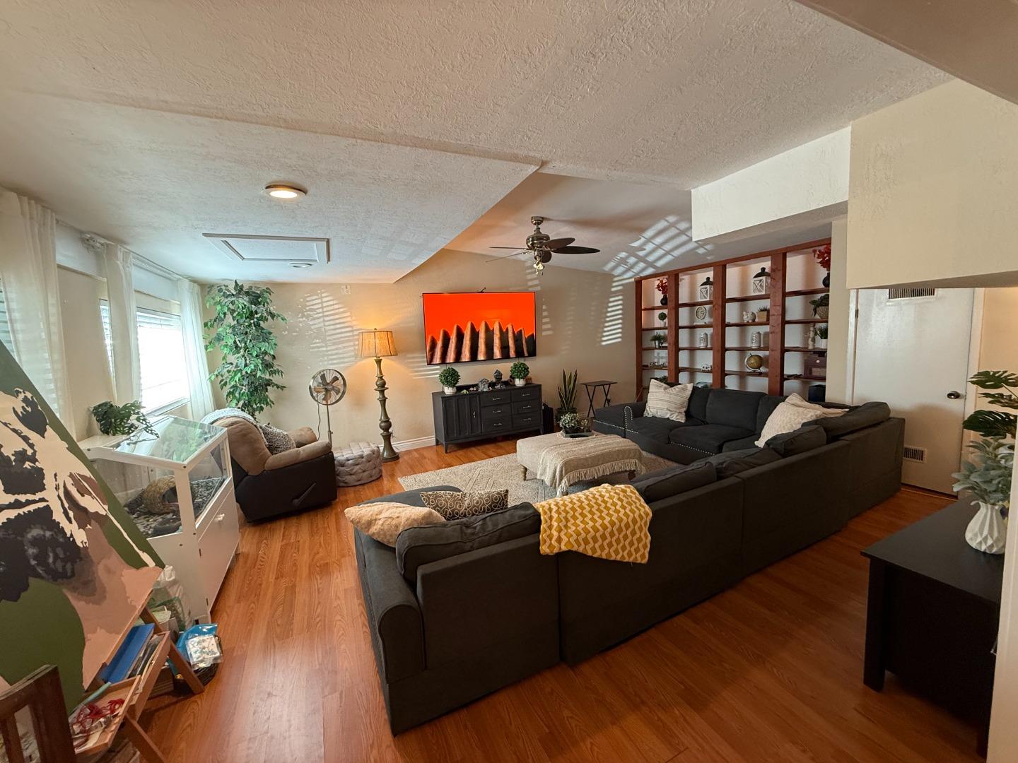 7610 Miller Avenue Gilroy, CA 95020 - Photo 7 of 49 a living room with furniture kitchen view and a wooden floor