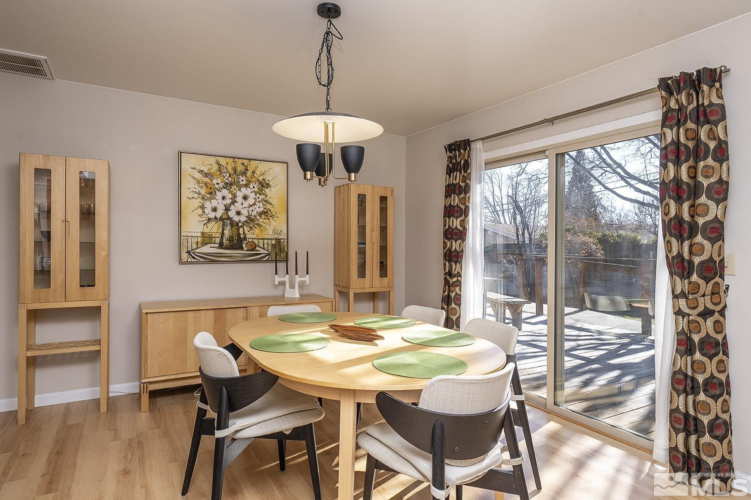 3310 Cashill Boulevard Reno, NV 89509 - Photo 12 of 40 a dining room with furniture a chandelier and wooden floor