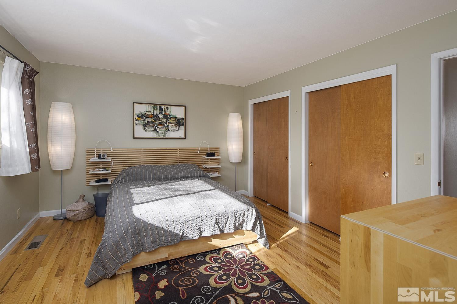 3310 Cashill Boulevard Reno, NV 89509 - Photo 20 of 40 a spacious bedroom with a bed and wooden floor