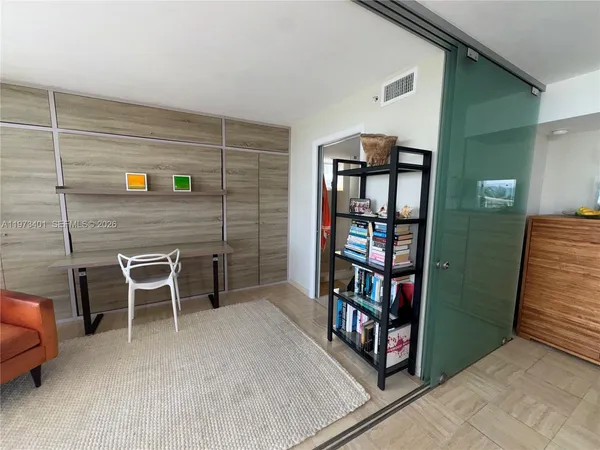 a view of a livingroom with furniture and staircase