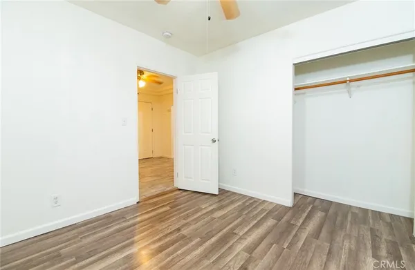 a view of a room with wooden floor and a window