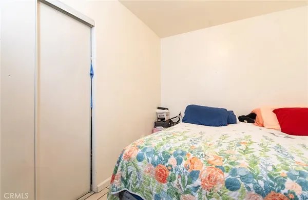 a bed sitting in a bedroom next to a window