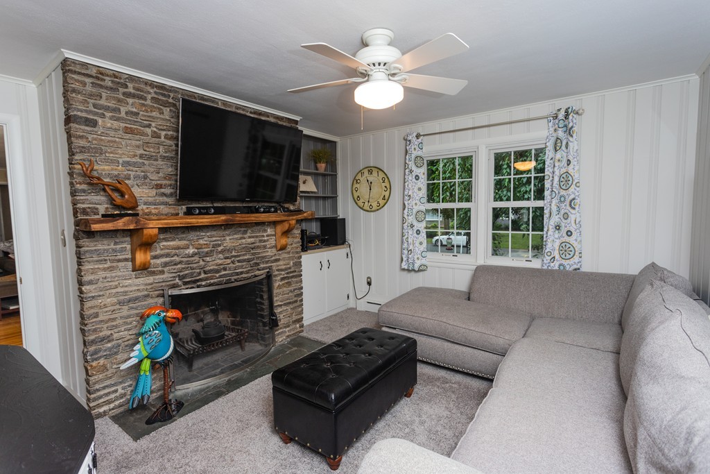 64 Ridge Road Longmeadow, MA 01106 - Photo 12 of 29 a living room with furniture a flat screen tv and a fireplace