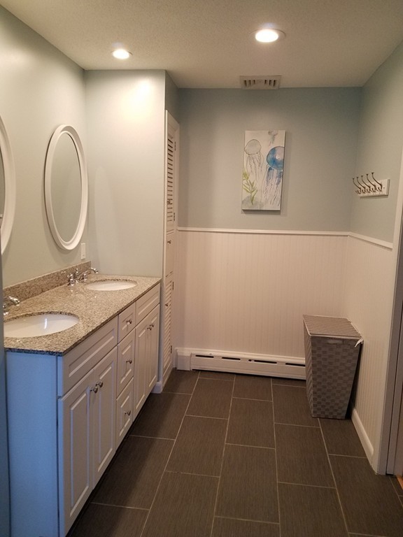 64 Ridge Road Longmeadow, MA 01106 - Photo 18 of 29 a bathroom with a granite countertop sink a mirror and a toilet