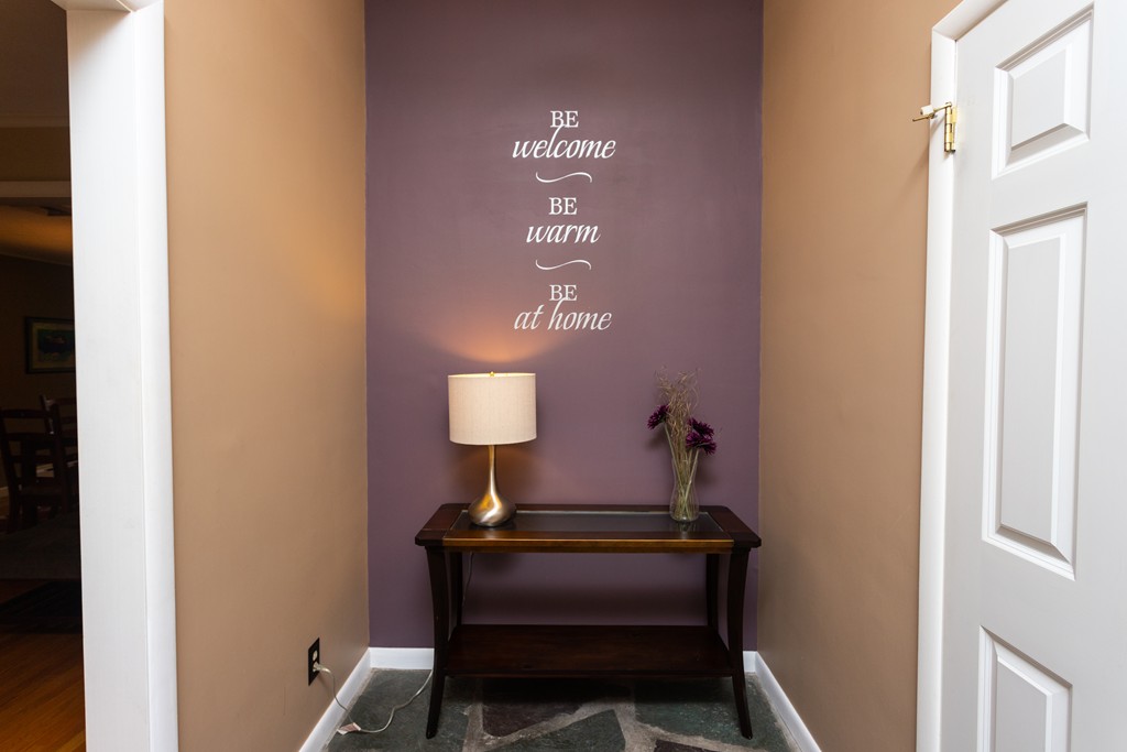 64 Ridge Road Longmeadow, MA 01106 - Photo 3 of 29 a lamp that has a sign on it and table in it