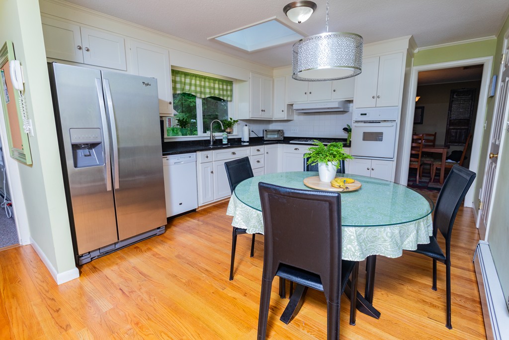 64 Ridge Road Longmeadow, MA 01106 - Photo 6 of 29 a kitchen with stainless steel appliances a dining table chairs refrigerator and sink