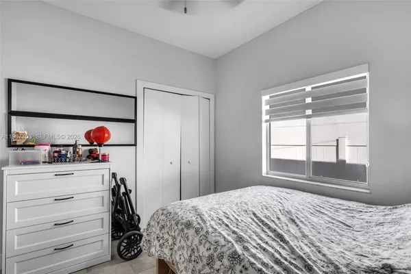 a bedroom with a bed and a window
