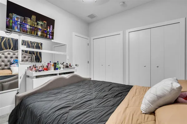 a bedroom with a bed and a book shelf