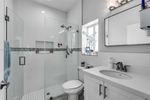 a bathroom with a sink a toilet and a mirror