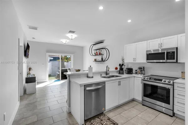 a kitchen with a sink stove and refrigerator