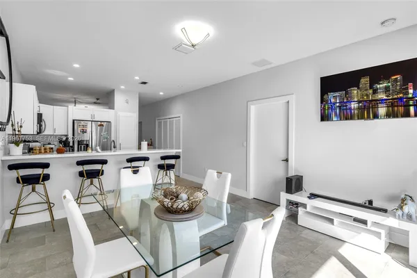 a kitchen with a dining table and chairs