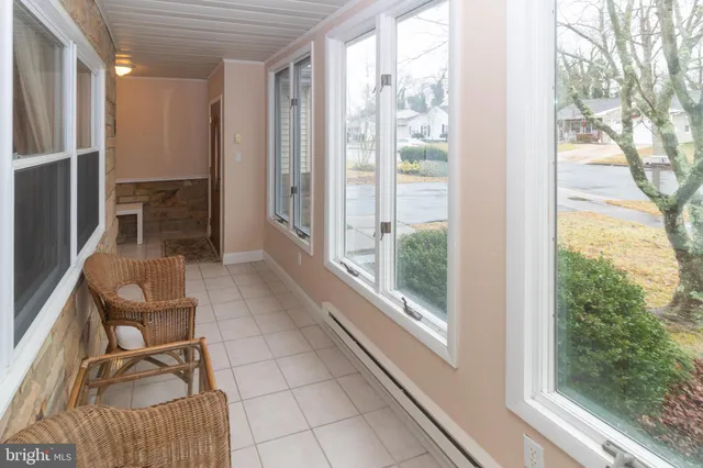 a room with patio furniture and a floor to ceiling window