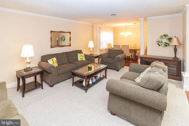 a living room with furniture and a lamp